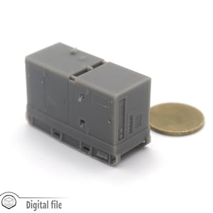 May include: A gray, rectangular, miniature model of a generator with a detailed design. The model is about the size of a U.S. quarter.