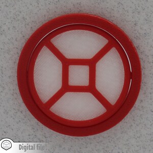 May include: Red plastic filter with a white mesh center. The filter has a square shape with rounded corners and a raised edge.