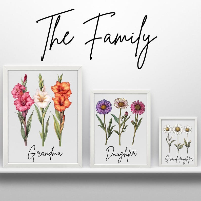 Three framed prints on a white shelf, with a large print of gladiolus labeled "Grandma," a medium print of asters labeled "Daughter," and a small print of daisies labeled "Grand-daughter," with "The Family" written above.