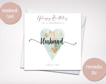 May include: Handmade card with a watercolor heart design. The card says "Happy Birthday to a Wonderful Husband" and "Love You".