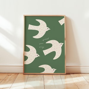 Può includere: Uno sfondo verde con quattro uccelli bianchi con macchie rosa. Gli uccelli stanno volando e il testo "spread your wings" è scritto in bianco sullo sfondo.