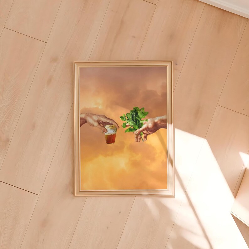 May include: A framed painting of two hands reaching towards each other, one holding a glass of tea and the other holding a sprig of mint.