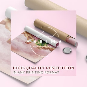 May include: A close-up of a rolled-up print with a pink background and a painting of two hands reaching towards each other. The print is labelled "Artisanat Herima Moroccan Wall Art Est. 2018".