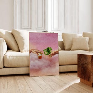 May include: A digital art print depicting two hands reaching towards each other, one holding a glass of tea and the other holding a sprig of mint. The background is a pink and white watercolour sky.