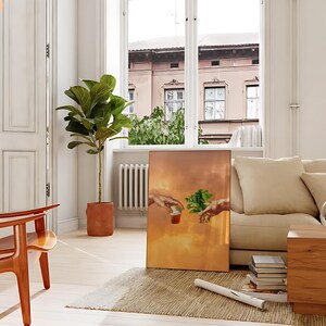 May include: A painting of two hands reaching towards each other, one holding a glass of liquid and the other holding a sprig of green leaves. The painting is set against a warm, orange background.