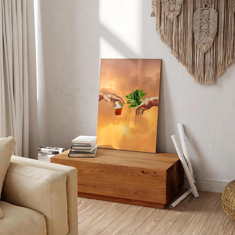 May include: A digital art print of a painting depicting two hands reaching towards each other. One hand is holding a small cup of liquid, while the other hand is holding a sprig of green leaves. The background is a soft orange and yellow gradient.
