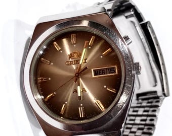 Reloj automático Orient vintage para hombre de los años 80, de acero inoxidable, con mecanismo mecánico, cristal y fecha.
