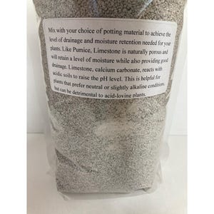 May include: A clear plastic bag filled with light gray potting mix. A white label with black text provides instructions for use, including drainage and moisture retention for plants. The mix contains pumice and limestone.