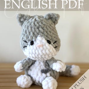May include: A handmade gray and white crochet cat plushie with black eyes and a pink nose. The cat has a gray and white spotted pattern and is labeled "Palm Plush Pets" and "English PDF". The text "Crochet Pattern" is also visible.
