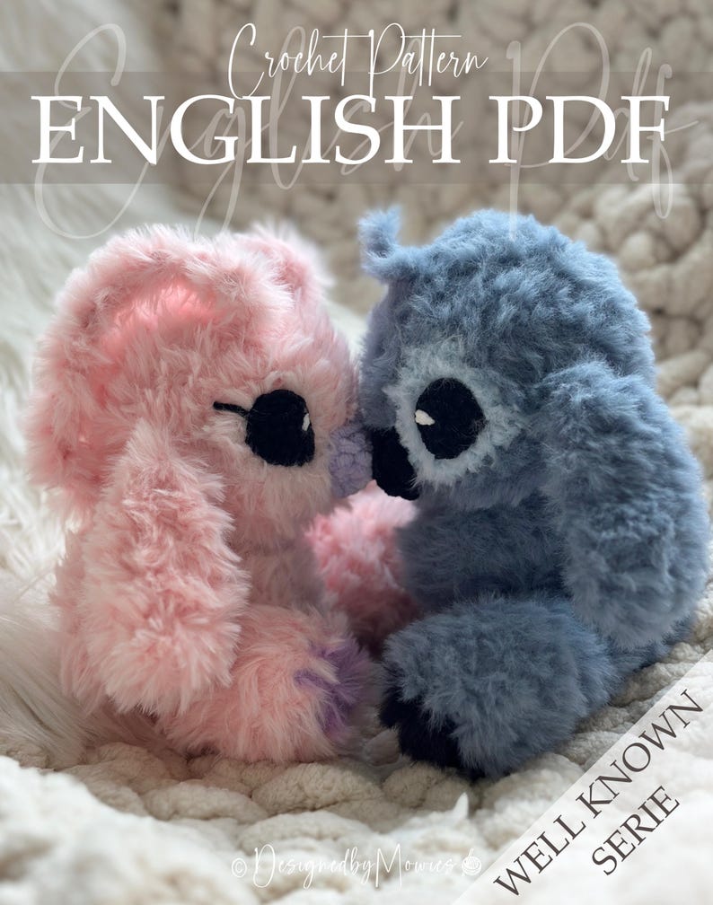 May include: Two plush stuffed animals made of fuzzy yarn, one light pink and one dusty blue, sitting side by side. They feature large black eyes and small dark noses. The text Crochet Pattern ENGLISH PDF and WELL KNOWN SERIE is visible.