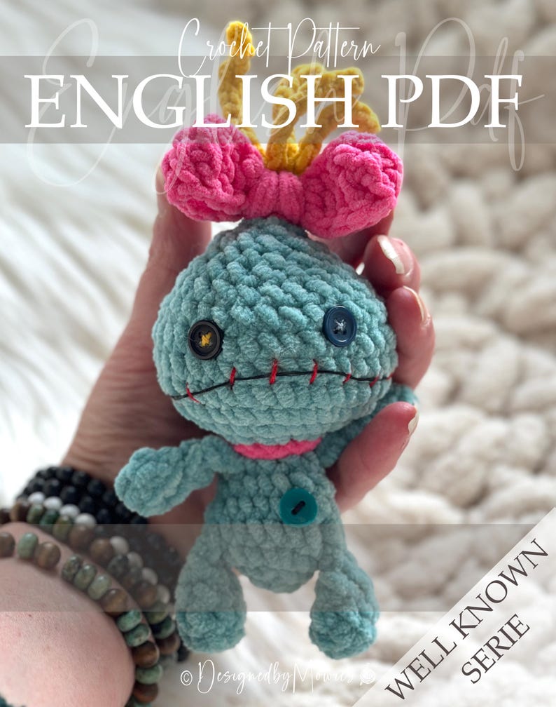 May include: A light blue crochet doll with a large head, a pink bow, and yellow hair. It features two mismatched buttons for eyes, a red stitched mouth, and a small blue button on its chest. The text reads Crochet Pattern ENGLISH PDF.