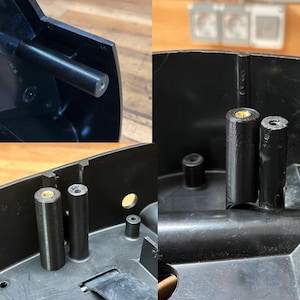 May include: Close-up shots of black plastic components, possibly from a larger device. The images show cylindrical posts and connecting parts, with a focus on the internal structure and assembly details. The parts appear to be new.