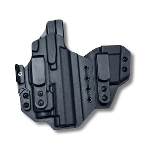 May include: Black molded polymer holster with two belt clips and multiple screw attachments. The holster has a textured surface and a series of eyelets for adjustable retention. The design is for a firearm.