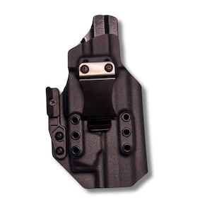 May include: A black, molded polymer holster with a metal belt clip. The holster features multiple mounting holes and adjustable retention. The design is textured for grip and durability. The holster is designed for concealed carry.