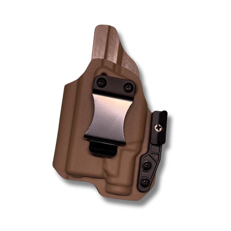 a brown holster with a black metal clip attached to it.