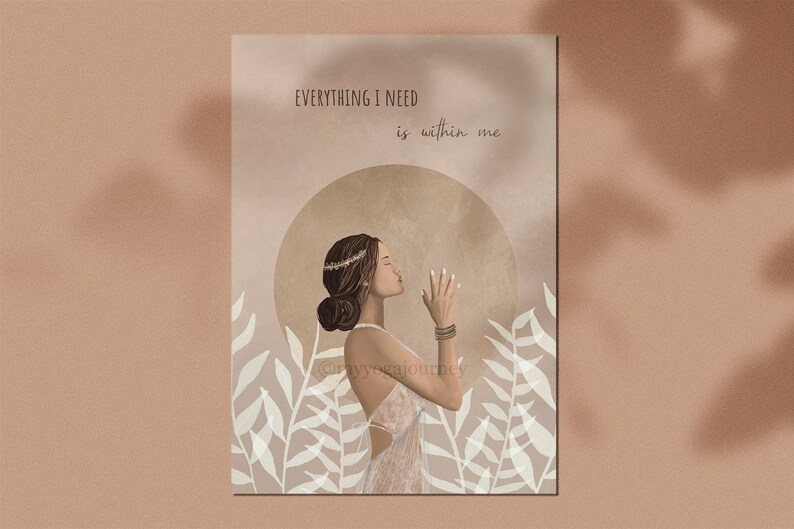 May include: An art print featuring a woman in a white dress with her hands clasped in prayer. The print has the text "EVERYTHING I NEED is within me" and is set against a beige background with floral accents. The artwork has a spiritual theme.