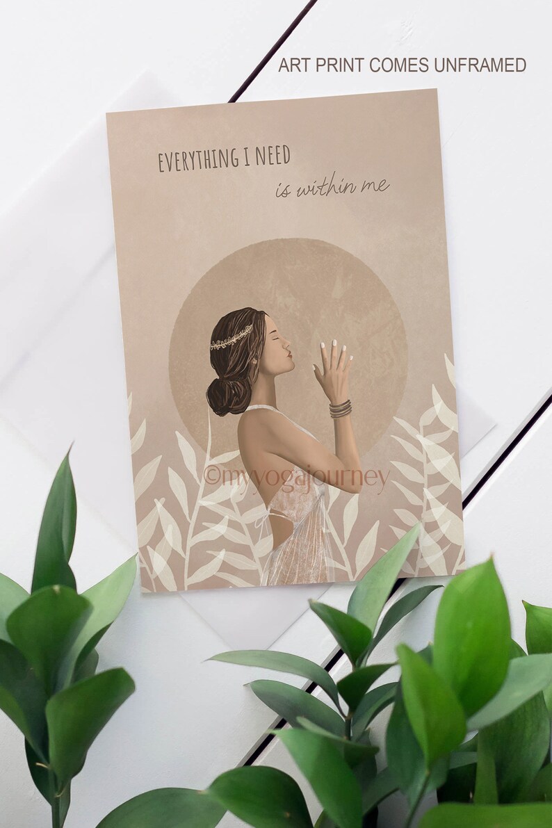 May include: Art print featuring a woman in profile with closed eyes, wearing a crown and bracelets, set against a beige background with the text "EVERYTHING I NEED is within me." The print has a boho aesthetic and includes botanical elements.