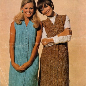 May include: Two women wearing sleeveless dresses with button closures. The dress on the left is light blue and the dress on the right is brown.