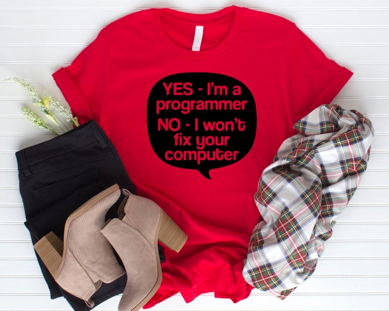 May include: Red t-shirt with a black speech bubble that says "YES - I'm a programmer NO - I won't fix your computer".