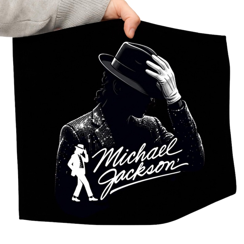 May include: Black graphic featuring a silhouette of Michael Jackson in a fedora and sequined jacket, with the text "Michael Jackson" in a stylized script. The image also includes a white silhouette of Jackson in a signature pose.