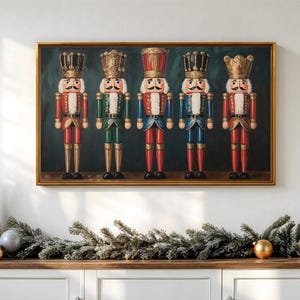 May include: A framed painting of five colorful nutcracker figures in red, green, and blue uniforms, each with a gold crown and mustache. The painting is set against a dark green background. A gold frame surrounds the artwork.