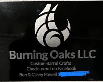May include: Black business card with the Burning Oaks LLC logo in silver. The card includes the text "Custom Barrel Crafts" and "Check us out on Facebook". The names Ben & Casey Powell are also listed.