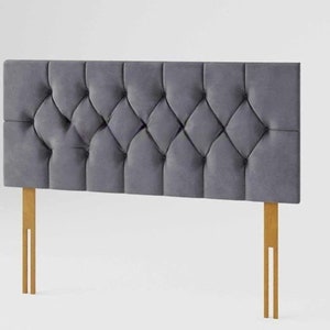 May include: A grey upholstered headboard with a diamond tufted design and wooden legs.