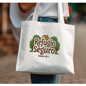 May include: White tote bag with a green and brown logo that says "Refugio Seguro" and "Salmo 46:1".