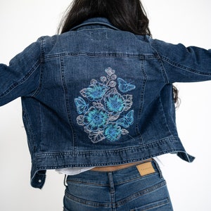 Embroidered denim fitted jacket for women. Blue flowers bouquet.
