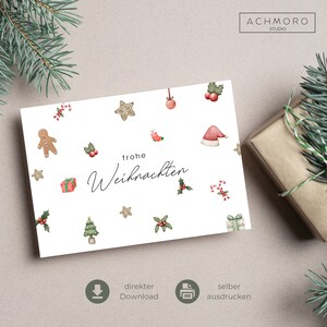 Può includere: Un biglietto di Natale bianco con un design di agrifoglio rosso e verde, un uomo di pan di zenzero, bastoncini di zucchero e il testo "frohe Weihnachten".