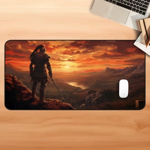 May include: A warrior in armor stands on a rocky cliff overlooking a valley at sunset. The sky is a vibrant orange and red, and the mountains in the distance are silhouetted against the horizon.