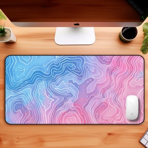 May include: A pink and blue desk mat with a white topographic pattern. A white computer mouse is on the mat.