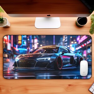 May include: A black sports car with red accents is driving through a city at night. The car has bright headlights and is surrounded by neon lights. The car is on a black mouse pad.