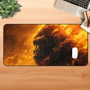 May include: A black and orange mouse mat featuring a close-up image of a gorilla's face engulfed in flames.