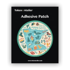May include: Adhesive patch featuring a map of Minnesota with various icons and text, including "Nice", "Camping", and "Twin Cities". The patch has a teal border and the text "Token Atelier" at the top.