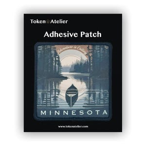 May include: Adhesive patch featuring a scenic lake landscape with a canoe, trees, and the word "MINNESOTA." The patch includes the text "Adventure is Calling" and the Token Atelier logo.