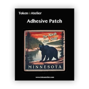 May include: An adhesive patch featuring a vintage illustration of a black bear standing on a riverbank in front of a sunset. The text "The North Star State" and "MINNESOTA" are printed on the patch.