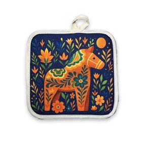 May include: Square pot holder with a navy blue background and a colorful Dala horse design. The horse is orange and yellow with floral patterns, surrounded by orange and green flowers. It has a white border and a loop for hanging.