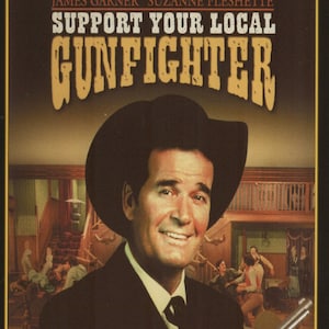 May include: A DVD cover for the movie "Support Your Local Gunfighter" starring James Garner and Suzanne Pleshette. The cover features a close-up of James Garner in a cowboy hat and suit, smiling at the camera. The background shows a saloon scene with people dancing and drinking.