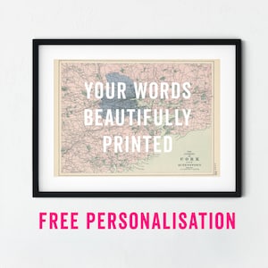 May include: Framed vintage map print of Cork, Ireland, with the text "YOUR WORDS BEAUTIFULLY PRINTED" in white. The map features a pink and blue color scheme. The frame is black.