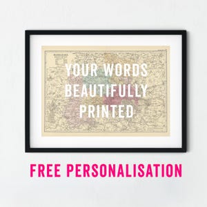 May include: Framed vintage map print with the text "YOUR WORDS BEAUTIFULLY PRINTED" in white. The map is in a black frame and has a cream-coloured background with colourful areas. The text "FREE PERSONALISATION" is below the frame.