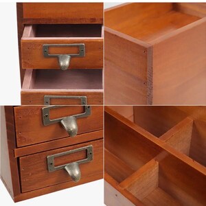 Close-up of wooden desk organiser drawers with metal handles