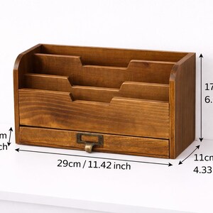 Wooden desk organiser with three compartments and drawer showing size measurements on a white background