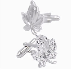 May include: Silver cufflinks with a leaf design. Each cufflink features a detailed, textured leaf.