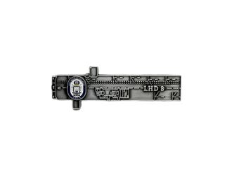 May include: A silver-colored metal pin with a detailed design. The pin features a central emblem with a blue and white crest, surrounded by intricate geometric patterns and the text "LHD 8".