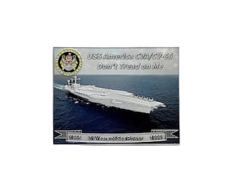 May include: A rectangular metal plaque featuring the USS America CVA/CV-66 aircraft carrier at sea. The plaque includes the text "Don't Tread on Me", the years 1965 and 1996, and the phrase "31 Years of Sea Power".