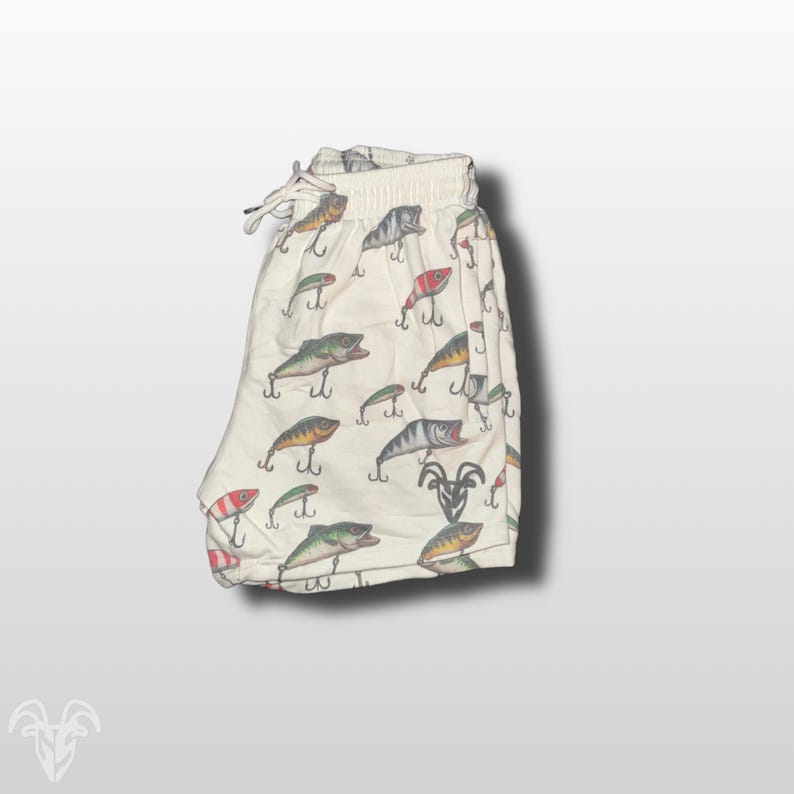 May include: White swim trunks with a pattern of colorful fishing lures.