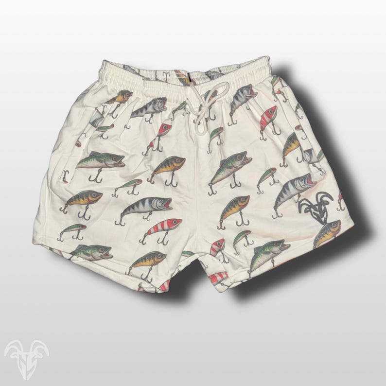 May include: White cotton shorts with a pattern of colorful fishing lures.