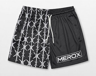 May include: Black athletic shorts featuring a white barbed wire pattern on the left leg and a solid black panel on the right leg. The shorts include a white drawstring at the elastic waistband and the text MEROX printed in a white box.