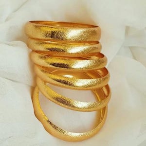 May include: A handmade wooden sign with the text "Welcome to our home" in a handwritten style. The sign is painted white with black lettering and a distressed finish, suitable for indoor or outdoor use.